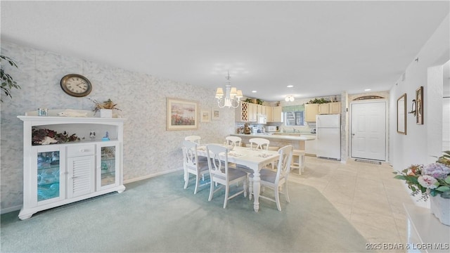 dining area featuring a chandelier, light tile patterned floors, recessed lighting, baseboards, and wallpapered walls