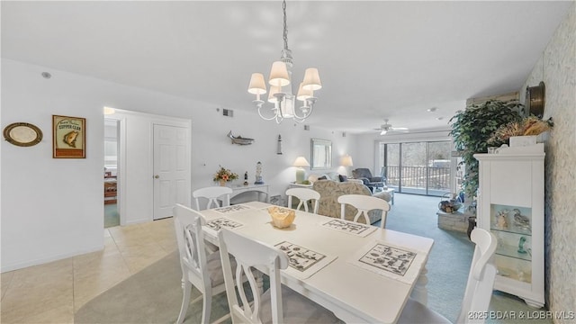 dining room with light tile patterned flooring and ceiling fan with notable chandelier