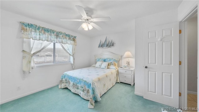 carpeted bedroom featuring ceiling fan and baseboards