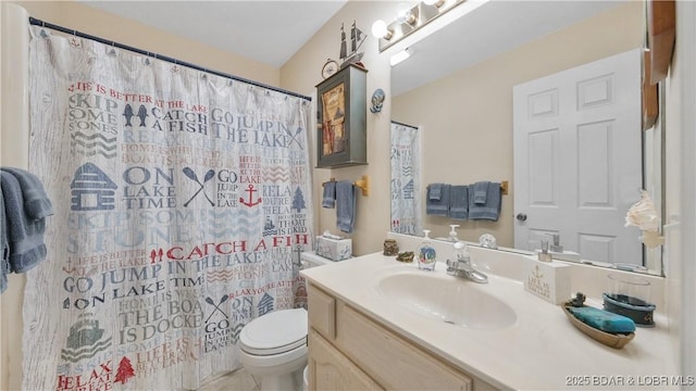 bathroom featuring curtained shower, vanity, and toilet