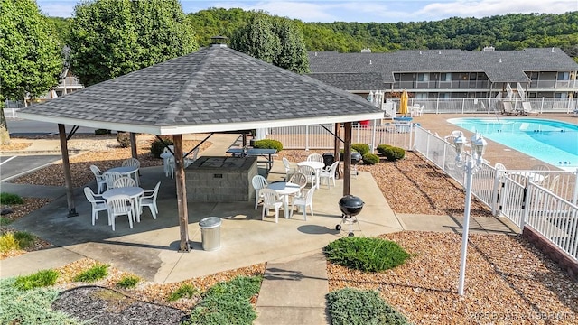 exterior space featuring a pool, fence, a gazebo, and a patio