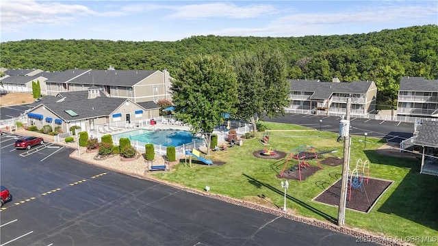 bird's eye view with a wooded view