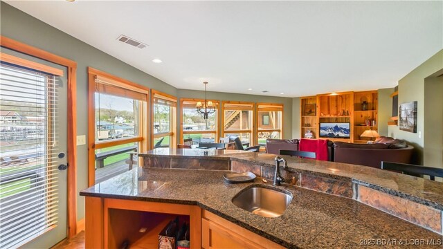 16959 Gentle Slopes Dr, Gravois Mills, MO 65037 - kitchen featuring a sink, healthy amount of natural light, a chandelier, dark stone counters, and recessed lighting