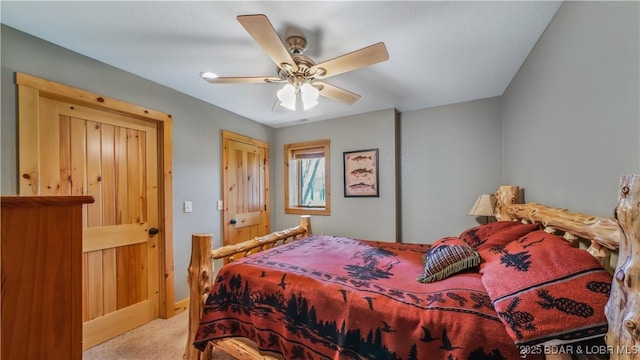 carpeted bedroom with a ceiling fan