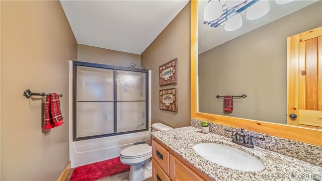 16959 Gentle Slopes Dr, Gravois Mills, MO 65037 - bathroom featuring vanity, toilet, combined bath / shower with glass door, and baseboards