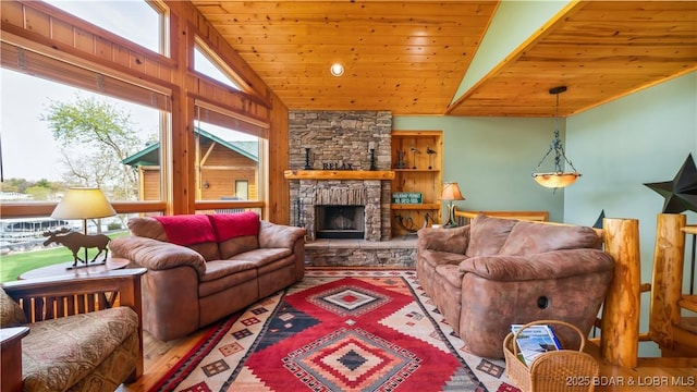 living room featuring lofted ceiling, wooden ceiling, a stone fireplace, and wood finished floors