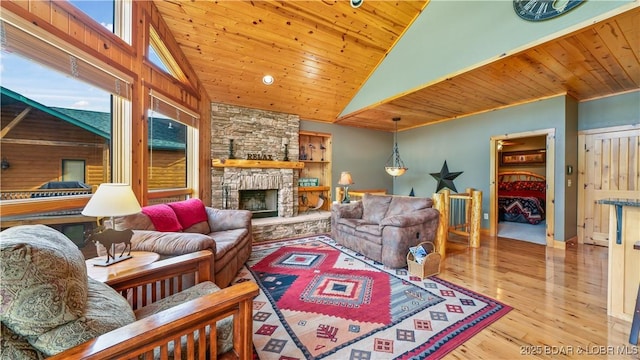 living room featuring high vaulted ceiling, a fireplace, wooden ceiling, and wood finished floors