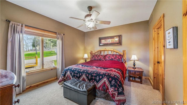 carpeted bedroom with ceiling fan and baseboards