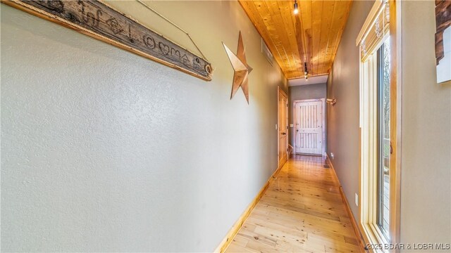 16959 Gentle Slopes Dr, Gravois Mills, MO 65037 - hallway with wooden ceiling, light wood-style floors, attic access, and baseboards