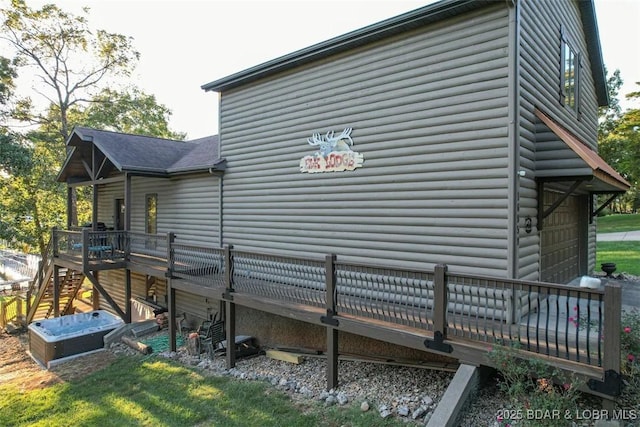 view of side of home featuring a deck and a garage