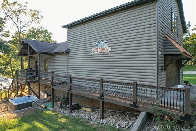 16959 Gentle Slopes Dr, Gravois Mills, MO 65037 - view of property exterior featuring a wooden deck, stairway, and an attached garage