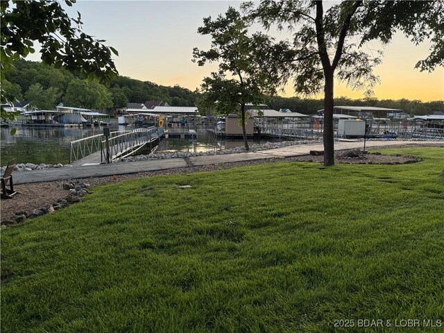 16959 Gentle Slopes Dr, Gravois Mills, MO 65037 - yard at dusk with a water view, a yard, and a boat dock