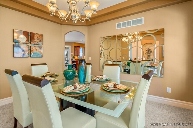 260 Greystone Ln, Villages, MO 65079 - dining space featuring a chandelier, arched walkways, visible vents, and baseboards