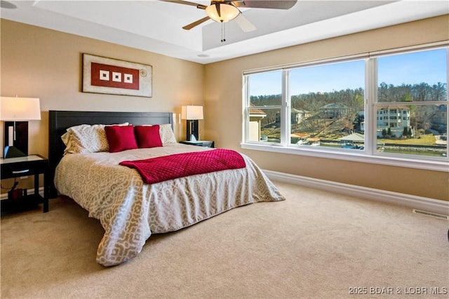 260 Greystone Ln, Villages, MO 65079 - carpeted bedroom featuring ceiling fan, a raised ceiling, visible vents, and baseboards