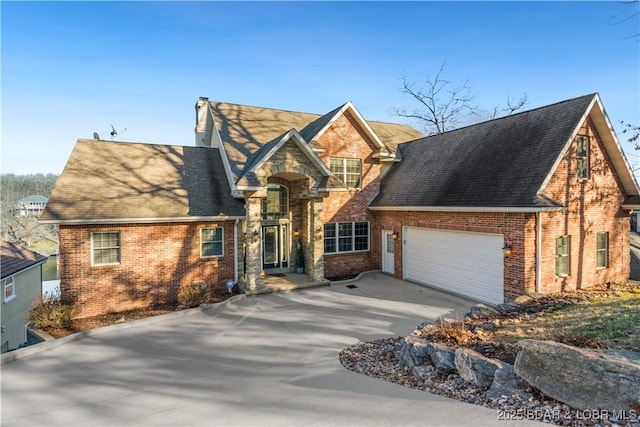 260 Greystone Ln, Villages, MO 65079 - view of front of property with an attached garage, driveway, a chimney, and brick siding