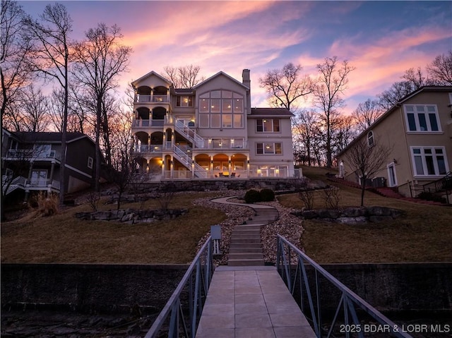 260 Greystone Ln, Villages, MO 65079 - back of house with a balcony, stairs, and a chimney