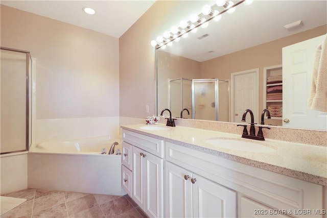 bathroom featuring a garden tub, double vanity, a stall shower, and a sink