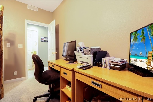 carpeted office featuring visible vents and baseboards