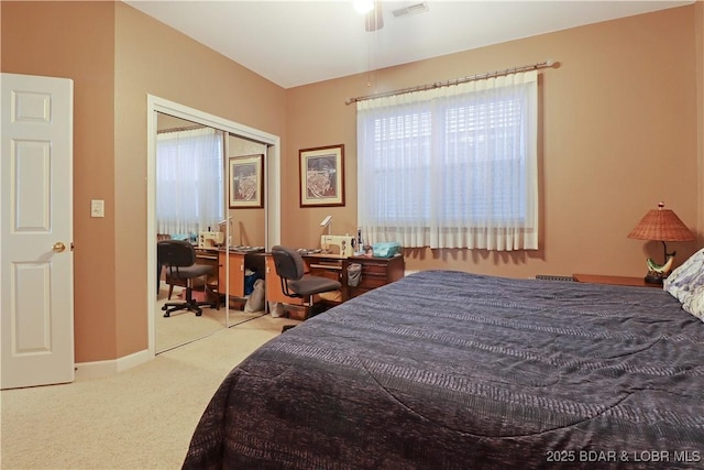 carpeted bedroom featuring baseboards, visible vents, and a closet