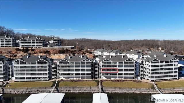 drone / aerial view with a water view and a residential view