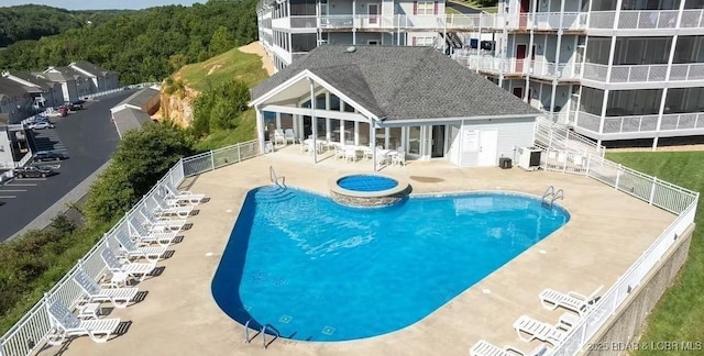 pool featuring a patio, central AC unit, fence, and a hot tub