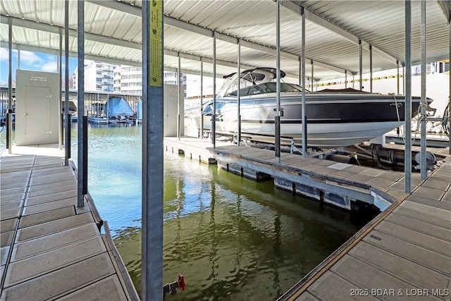 dock area with a water view and boat lift