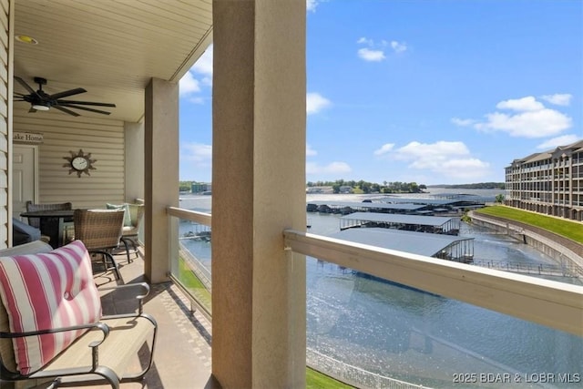 balcony with a water view and ceiling fan