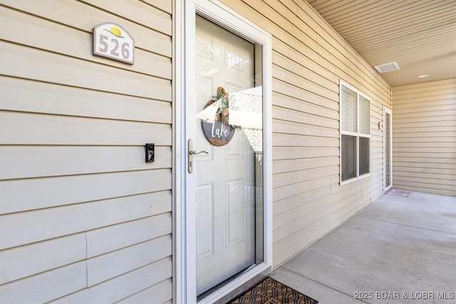 view of exterior entry with covered porch