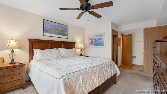 bedroom featuring light carpet and ceiling fan