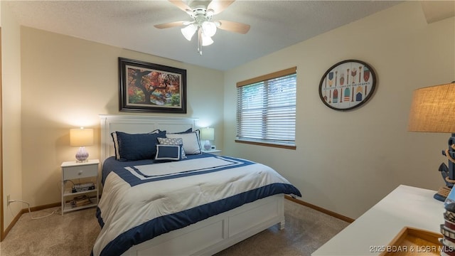 carpeted bedroom featuring ceiling fan, baseboards, and a textured ceiling