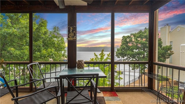 sunroom / solarium with plenty of natural light and a water view