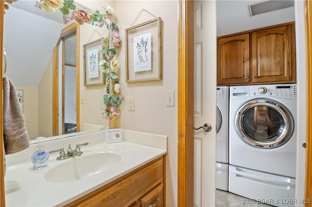 bathroom featuring washing machine and dryer and vanity