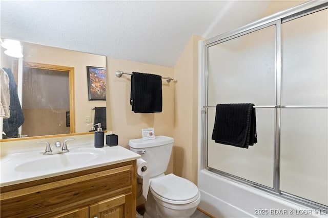 bathroom with combined bath / shower with glass door, vanity, and toilet