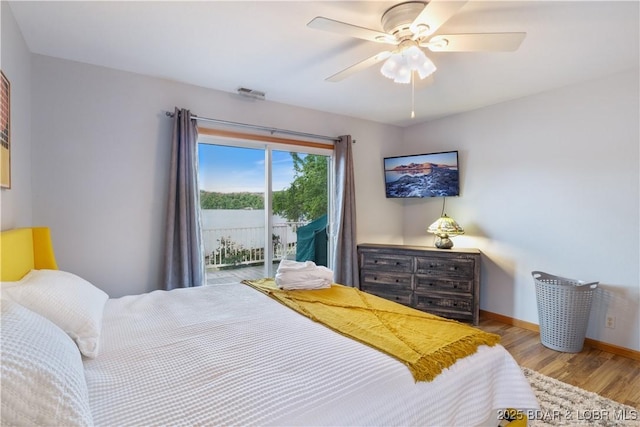 bedroom featuring visible vents, a ceiling fan, wood finished floors, access to outside, and baseboards