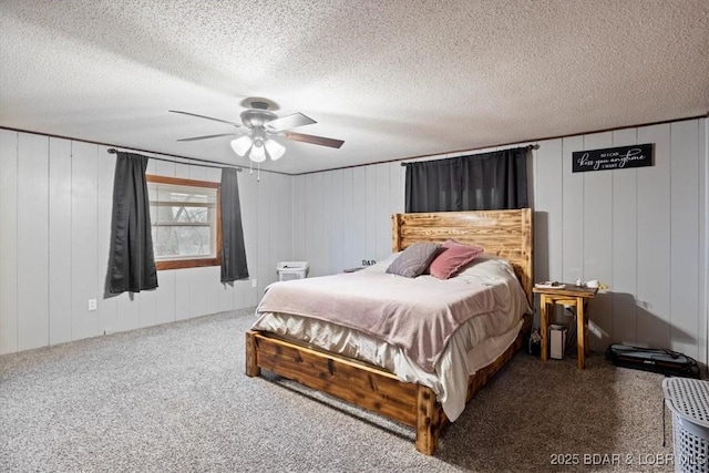 carpeted bedroom featuring a textured ceiling and a ceiling fan