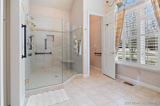 bathroom featuring baseboards, visible vents, tile patterned flooring, and a stall shower