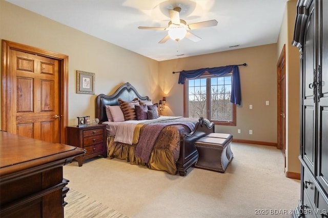 bedroom with a ceiling fan, light colored carpet, and baseboards