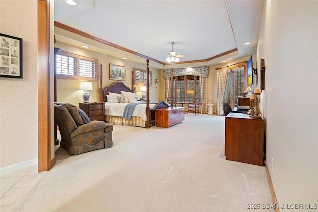 carpeted bedroom with a tray ceiling, recessed lighting, and baseboards