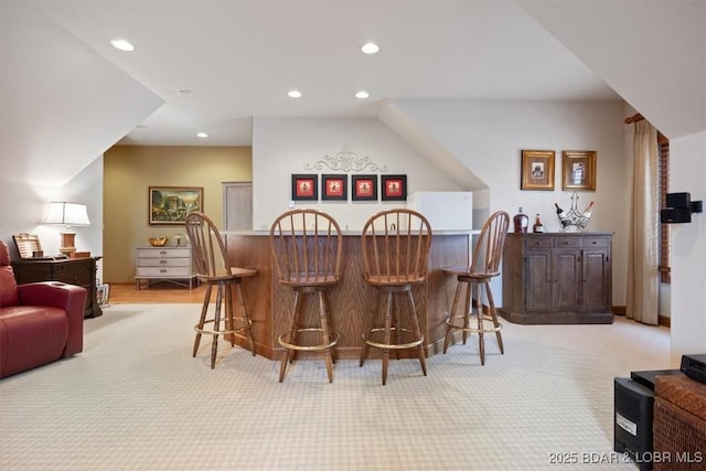 bar featuring a bar, light carpet, and recessed lighting