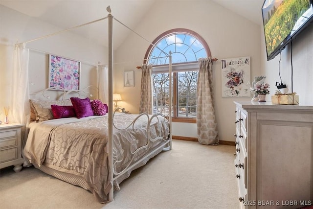 bedroom with light carpet, vaulted ceiling, and baseboards