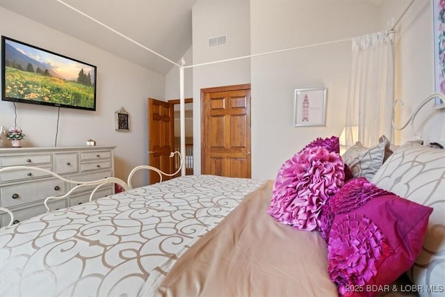 bedroom featuring visible vents and vaulted ceiling