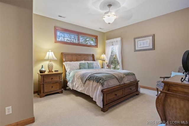 bedroom featuring baseboards, visible vents, and light colored carpet