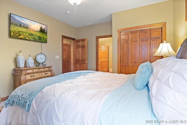 bedroom featuring a closet and visible vents
