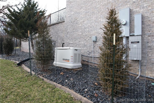 exterior details with electric meter, a power unit, and brick siding