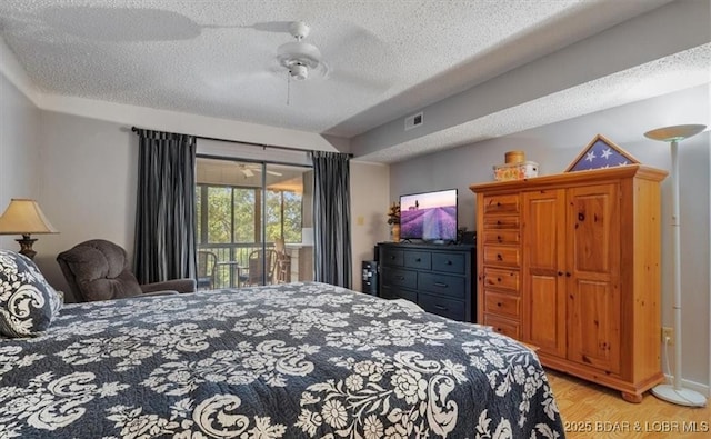 71 Costa Del Sol Dr Unit 207, Lake Ozark, MO 65049 - bedroom with access to outside, ceiling fan, a textured ceiling, visible vents, and light wood finished floors