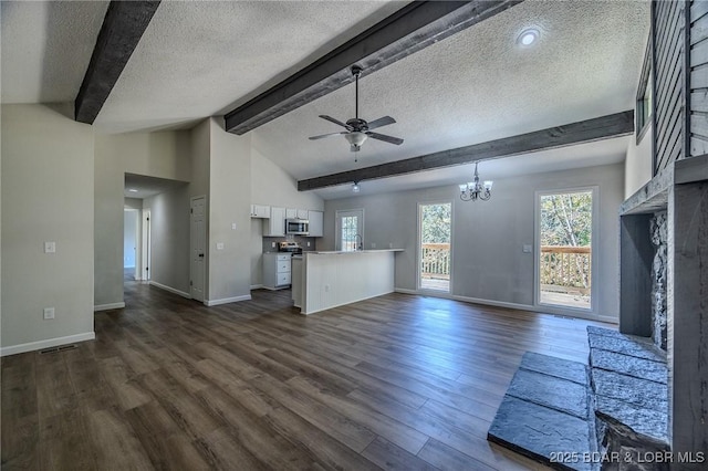 unfurnished living room featuring dark wood-style floors, lofted ceiling with beams, a textured ceiling, and ceiling fan with notable chandelier