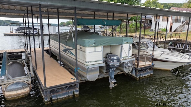 dock area with a water view and boat lift