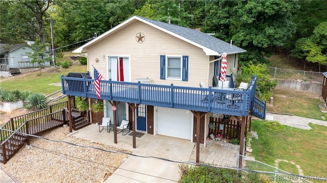 view of front facade featuring a garage, a front yard, fence, and stairway