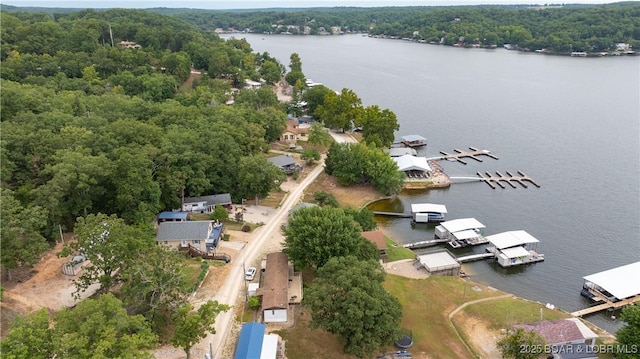 aerial view featuring a water view and a wooded view