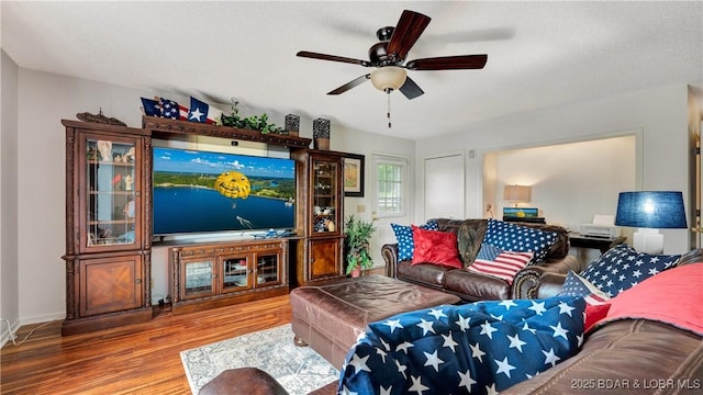 living area featuring ceiling fan and wood finished floors